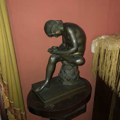 Boy Pulling Thorn Out of His Foot