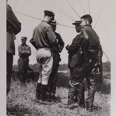 Men in a field with a dirigible