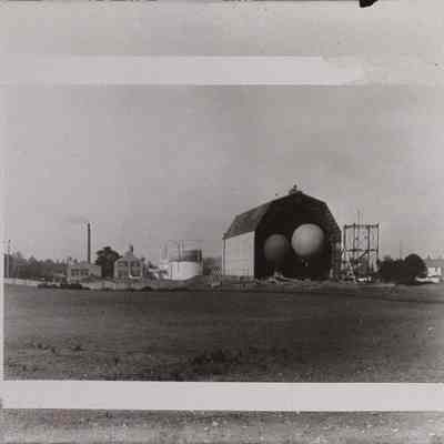 Two round balloons at door of hangar