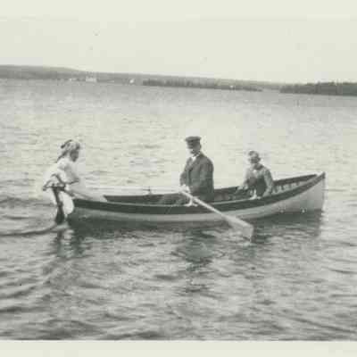Three people in a row boat