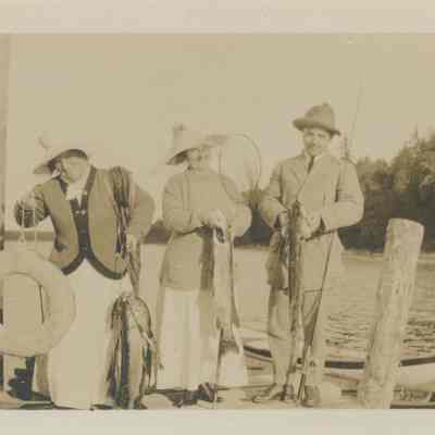 Three people on a dock