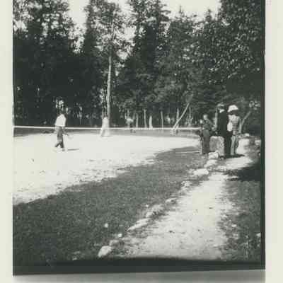 People playing tennis at Cedar Lodge