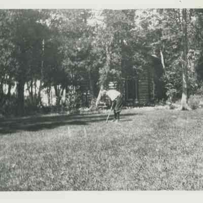 Young boy playing croquet