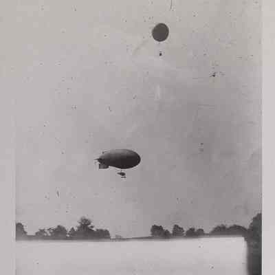 Distant view of a weather balloon and dirigible in the air