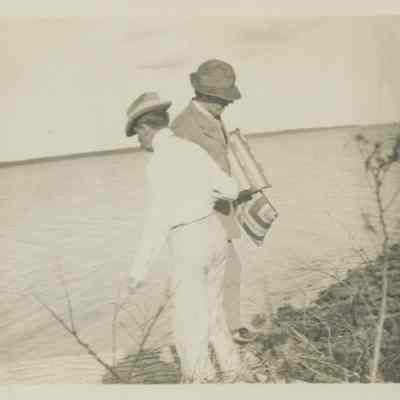 Two men on a rocky shoreline