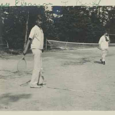 Three people playing tennis