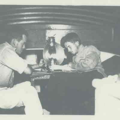 Two young men in cabin of boat