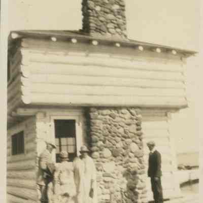 Four people near the Block House at Cedar Lodge