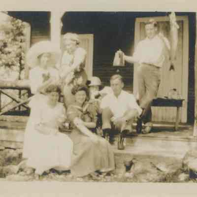 Group of people on the porch of the Main Cabin at Cedar Lodge