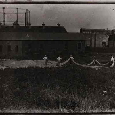 Six men with deflated observation balloon