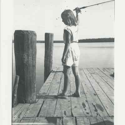 Young girl fishing from a dock