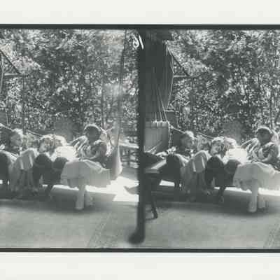 Four young people relaxing on a large porch swing