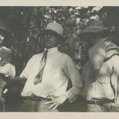 Three people in wooded area