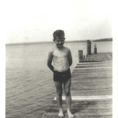 Young boy standing on a dock