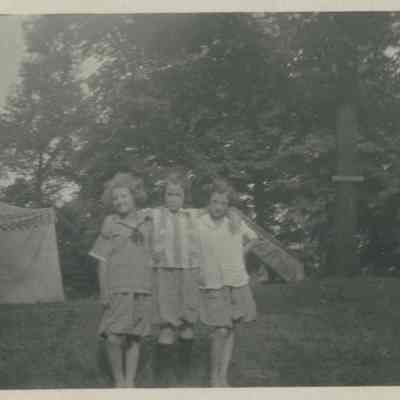 Three girls posed at a campground