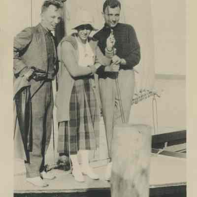 Three people on a sailboat