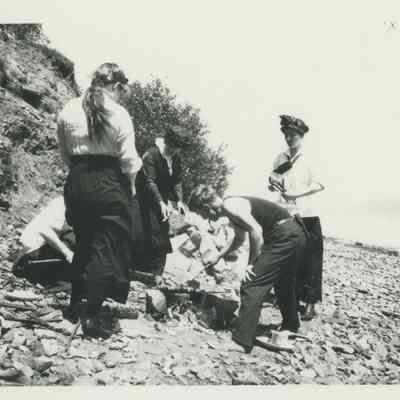 Young people cooking over an open fire