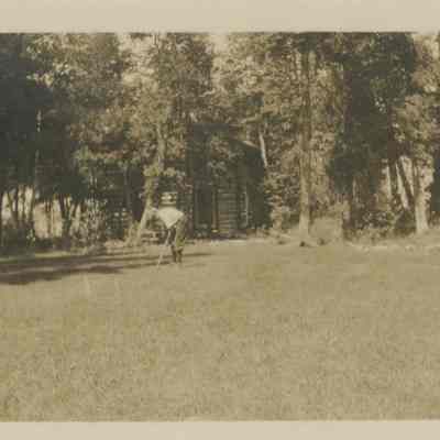 Young boy playing croquet