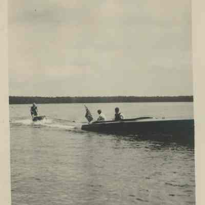 Three people enjoying wakeboarding