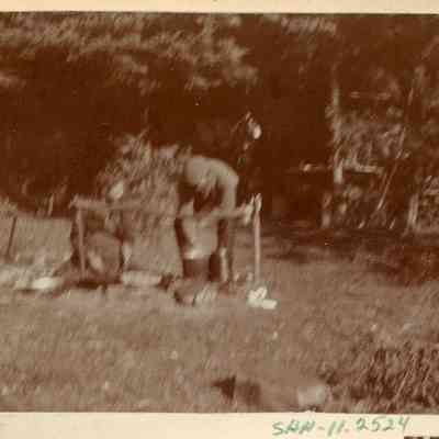Two people at a cook fire