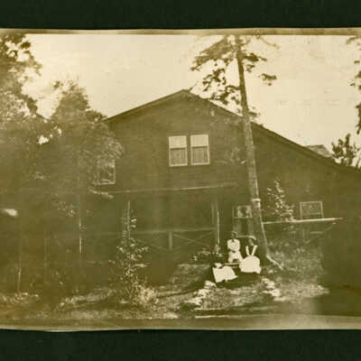 Three domestic staff members on the steps at Cedar Lodge