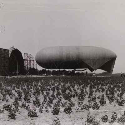 Dirigible tethered outside hangar