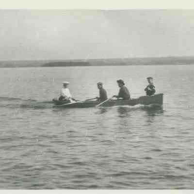 Four people rowing on Lake Huron