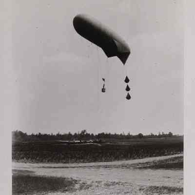 Observation balloon in flight with 2 men in basket below