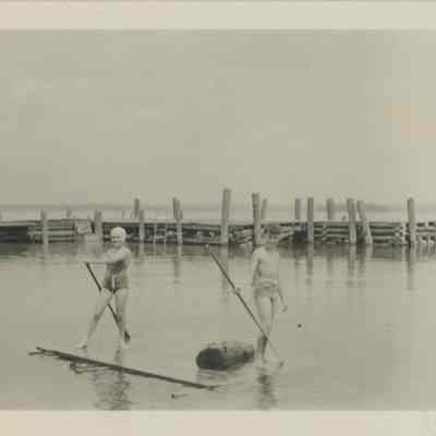 Two children playing in the lake