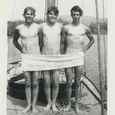 Three young men on a sailboat