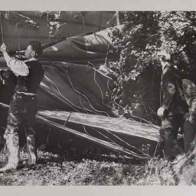 Four men around crashed dirigible