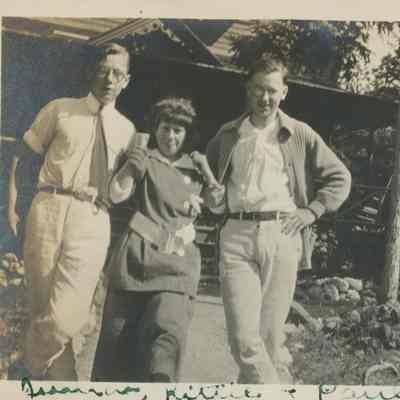 Three people in front of cottage at SunSands