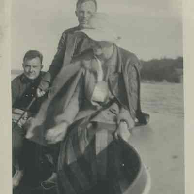Three people on a sailboat