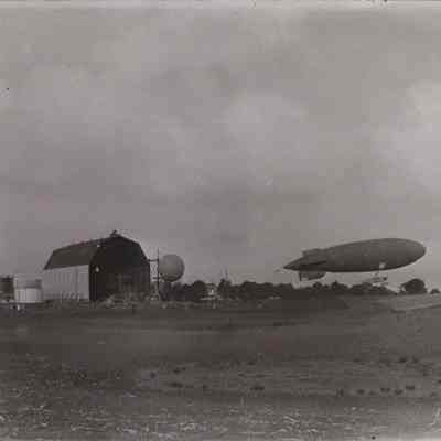 Dirigible and balloon outside hangar
