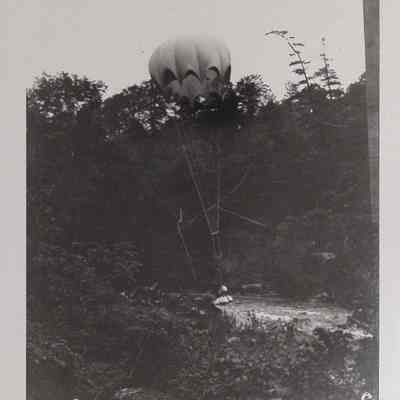 Weighted parachute being dropped from a bridge