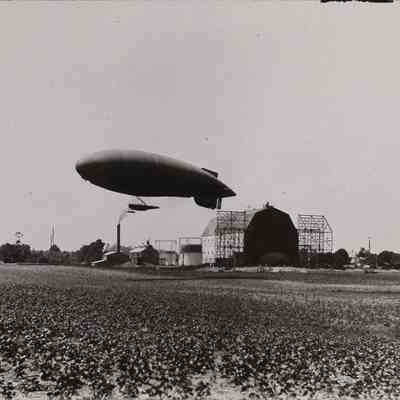 Dirigible lifting off near hangar