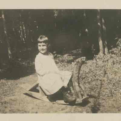 Young girl on a rocking horse