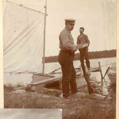 F.A. Seiberling on lakeshore near boats