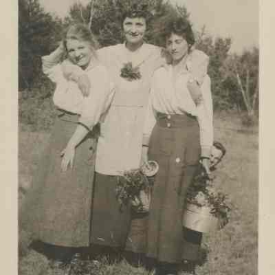 Three woman picking flowers