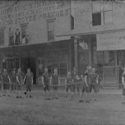 Men in long johns pulling fire hose