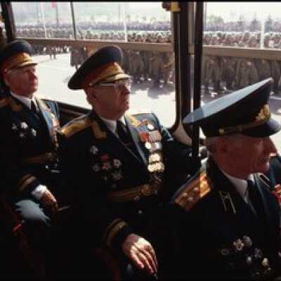 Russian military men ride bus, while other soldiers march outside on their way to celebrate the 50th anniversary of VE day, Moscow, Russia