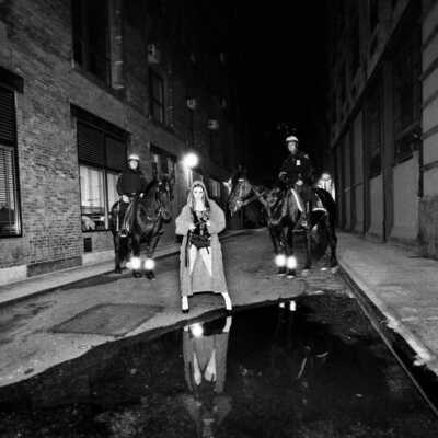 Tribeca Young woman in Staple Alley with Mounted Police behind her sends a message to the Pope "Make the priests Stop Abusing Children or Else"