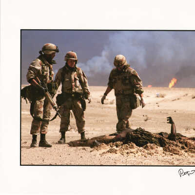 Three U.S. soldiers look over the burnt corpse of an Iraqi soldier before burying it on the day after the Gulf War ended, Kuwait
