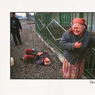 A woman cries after another woman is hit by a Russian shell during the war in Chechnya, Grozny, Chechnya