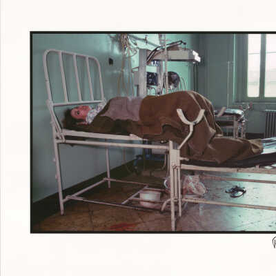 An Albanian woman lies on a rickety delivery table in a spartan delivery room, Tirane, Albania