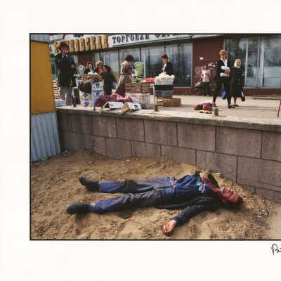 Drunk man lying in the dirt near a market, Kirov, Russia