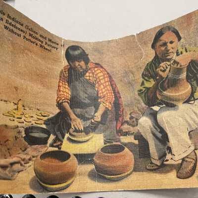 Postcard & envelope found in pot.: Picture of front of postcard with image of Marie & Julian Martinez of San Ildefonso Pueblo making pottery.