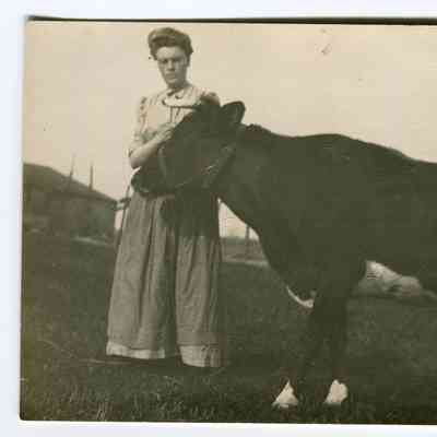 Woman and cow, postcard