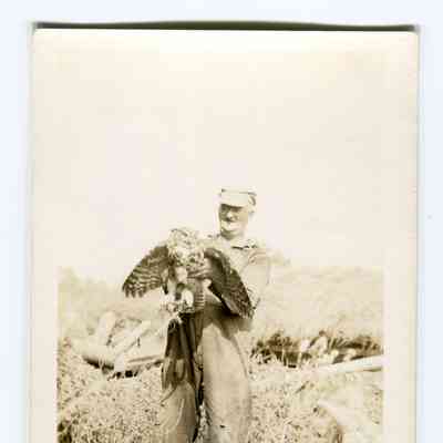 Postcard of George Dodge holding an owl
