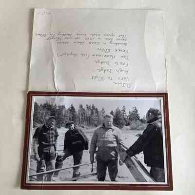 Photo of four men building a “crab fence”